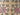 Holly - A floral-patterned rug with green and red flowers on a mustard background.